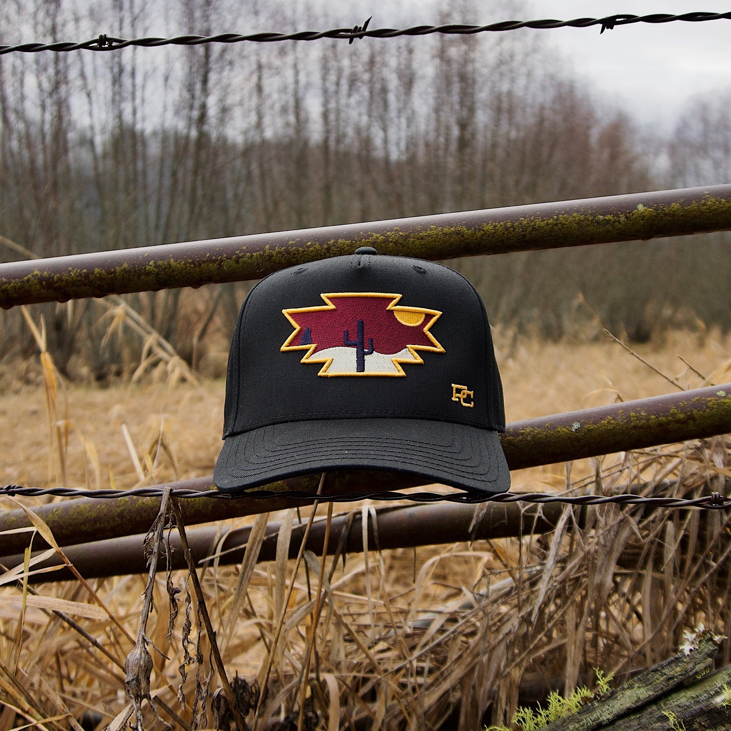 a hat is sitting on top of a fence